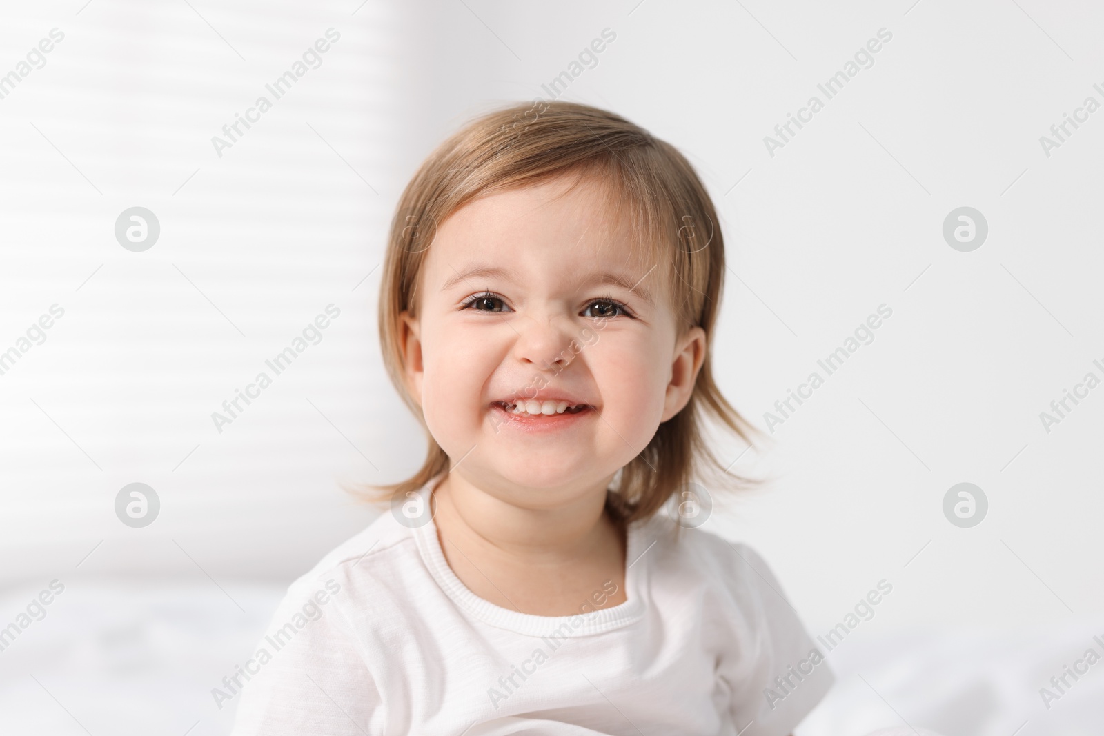 Photo of Portrait of cute little baby girl on light background