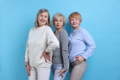 Photo of Friendship. Portrait of senior women on light blue background