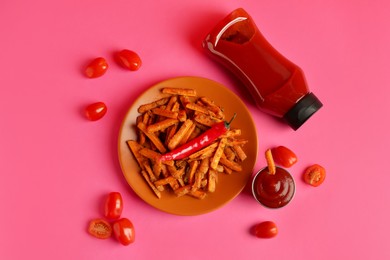 Photo of Tasty ketchup, tomatoes and fried carrots on color background