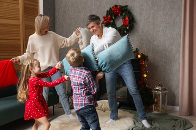 Family having pillow fight at home. Christmas season