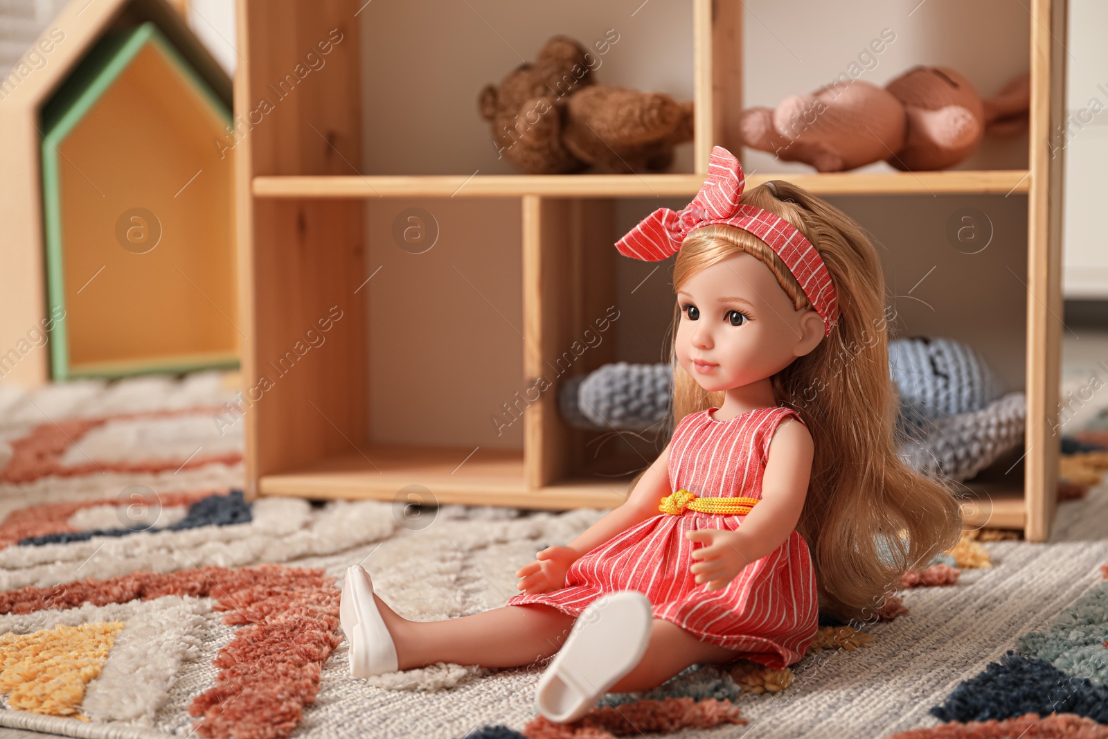 Photo of Beautiful doll and other toys on soft carpet indoors. Space for text