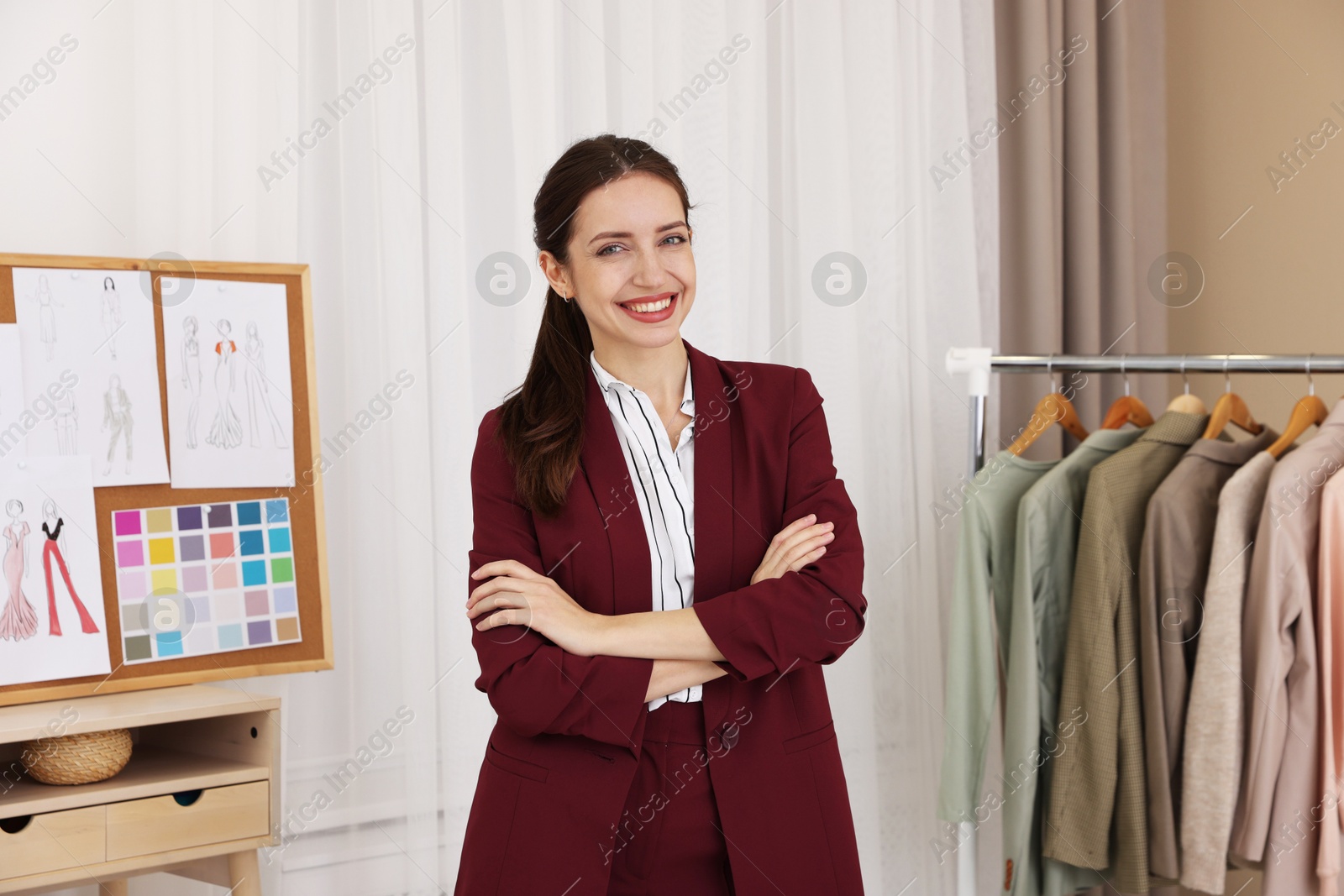 Photo of Fashion designer with crossed arms in workshop