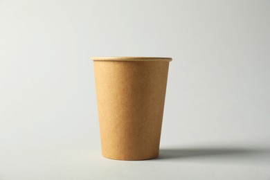 Photo of Paper cup on grey background. Mockup for design