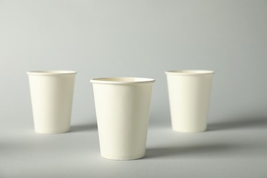 Photo of Paper cups on grey background. Mockup for design