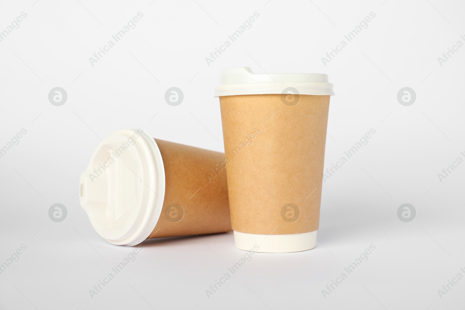 Paper cups on white background. Mockup for design Photo of Paper cups on white background. Mockup for design