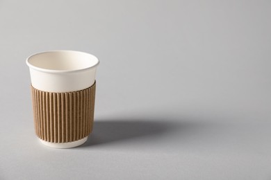 Photo of Paper cup on grey background. Mockup for design
