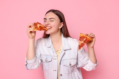 Beautiful woman with delicious pizza on pink background