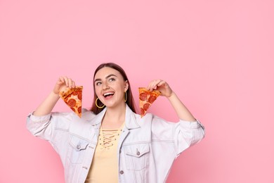 Beautiful woman with delicious pizza on pink background, space for text