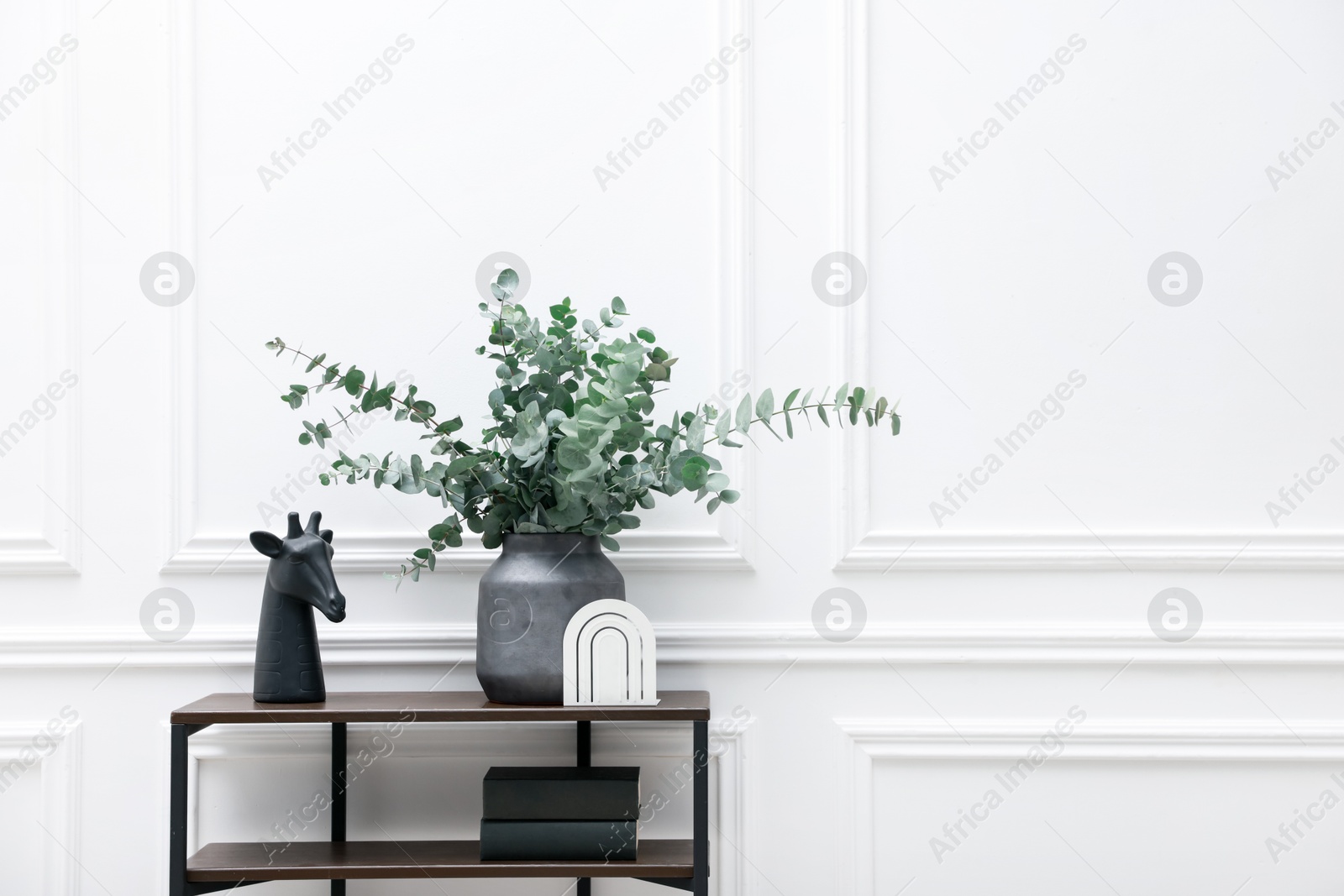 Photo of Console table with decor near white wall in room, space for text. Interior design