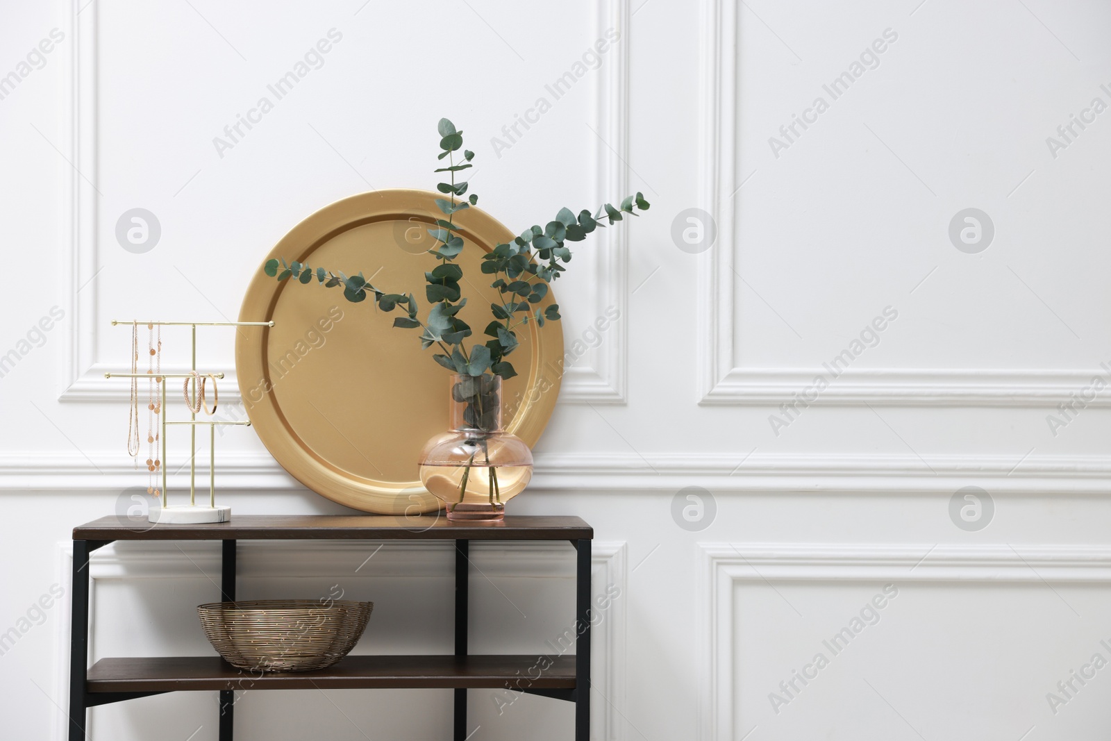 Photo of Console table with decor near white wall in room, space for text. Interior design