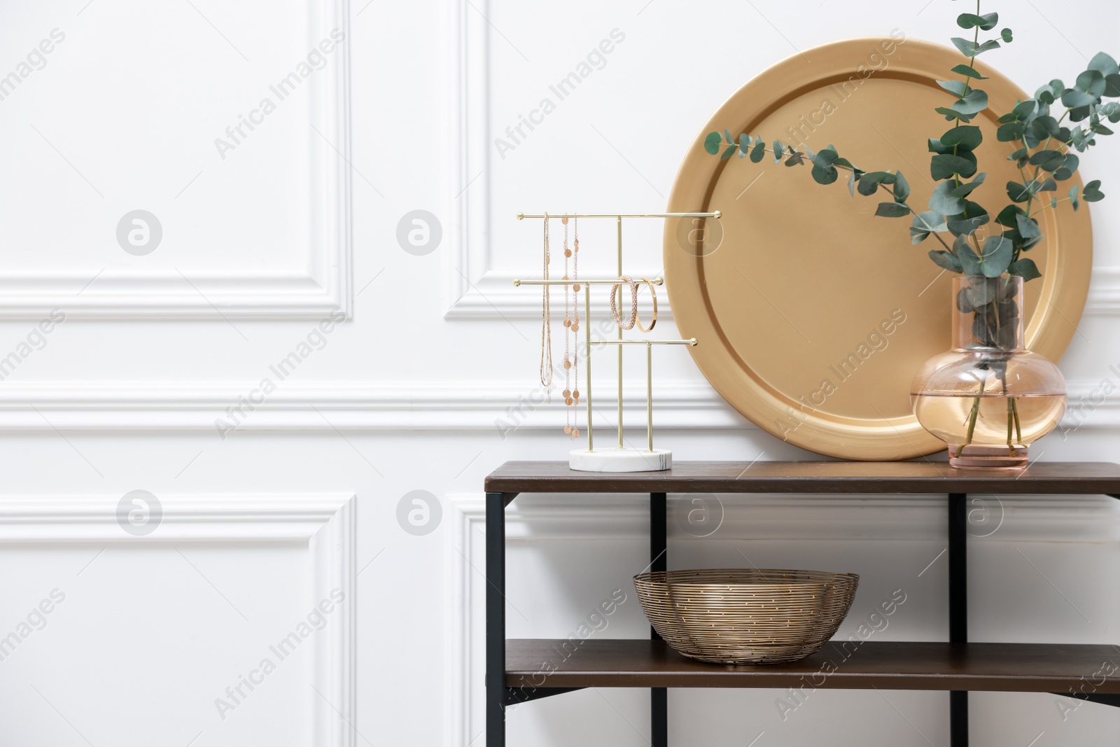 Photo of Console table with decor near white wall in room, space for text. Interior design