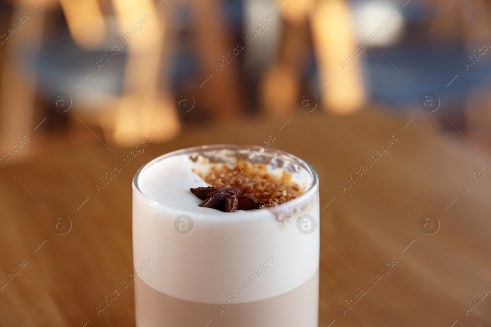 Photo of Glass of aromatic coffee on table in cafe, closeup