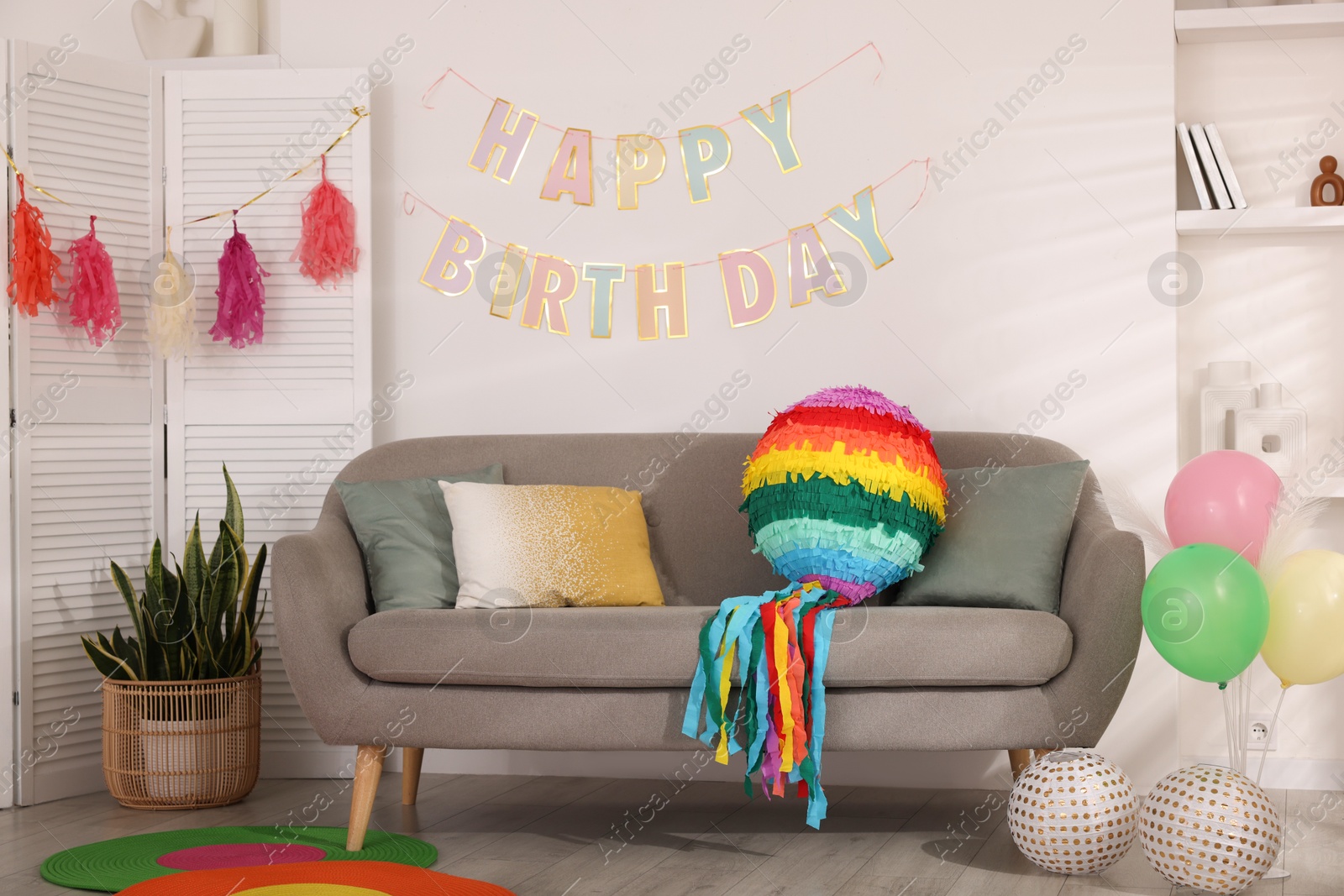 Photo of Colorful pinata and party accessories in festive decorated room