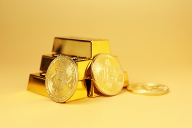 Photo of Gold bars and coins on golden background, closeup