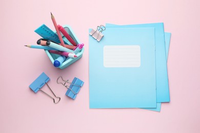 Photo of Copybooks and other school stationery on pink background, flat lay