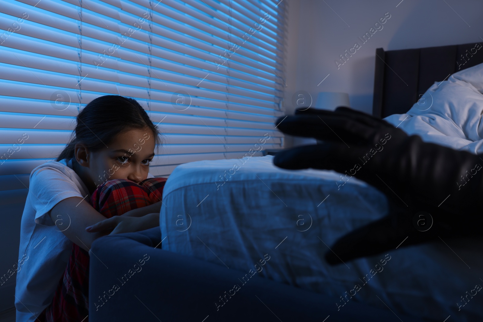 Photo of Bogeymen reaching for scared girl in bedroom at night, closeup