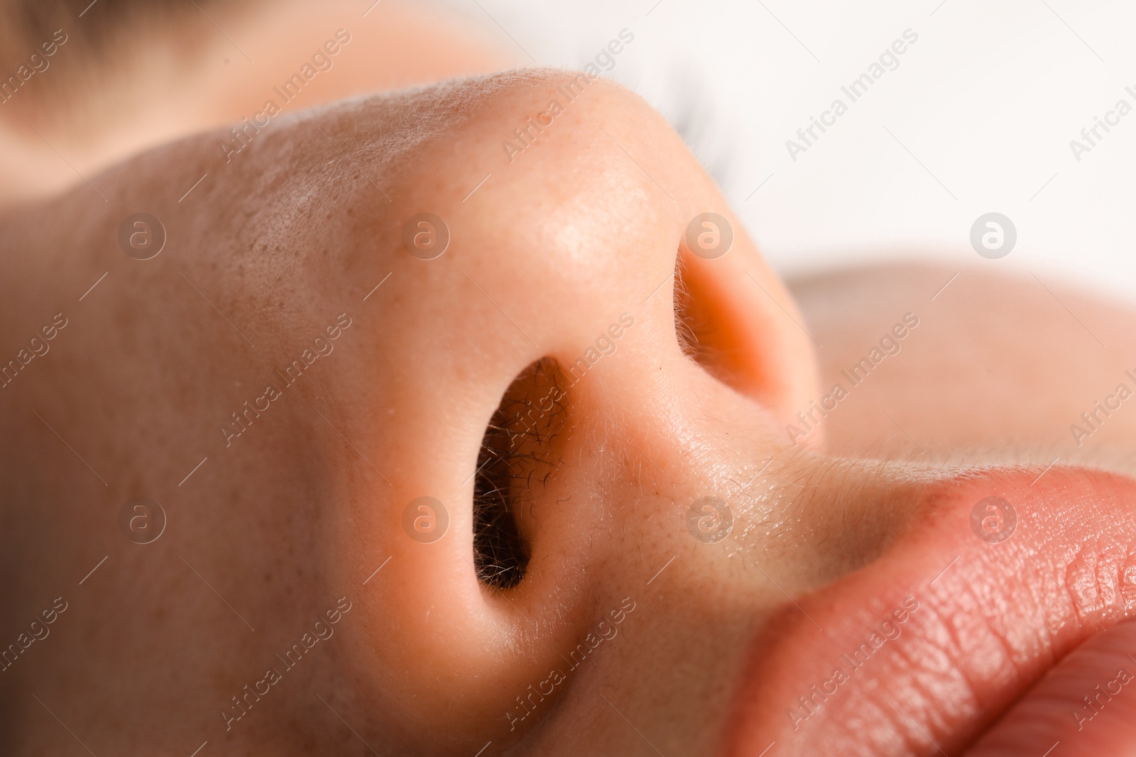 Photo of Woman with normal nasal septum on light background, closeup