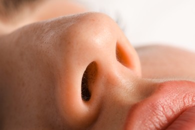 Woman with normal nasal septum on light background, closeup