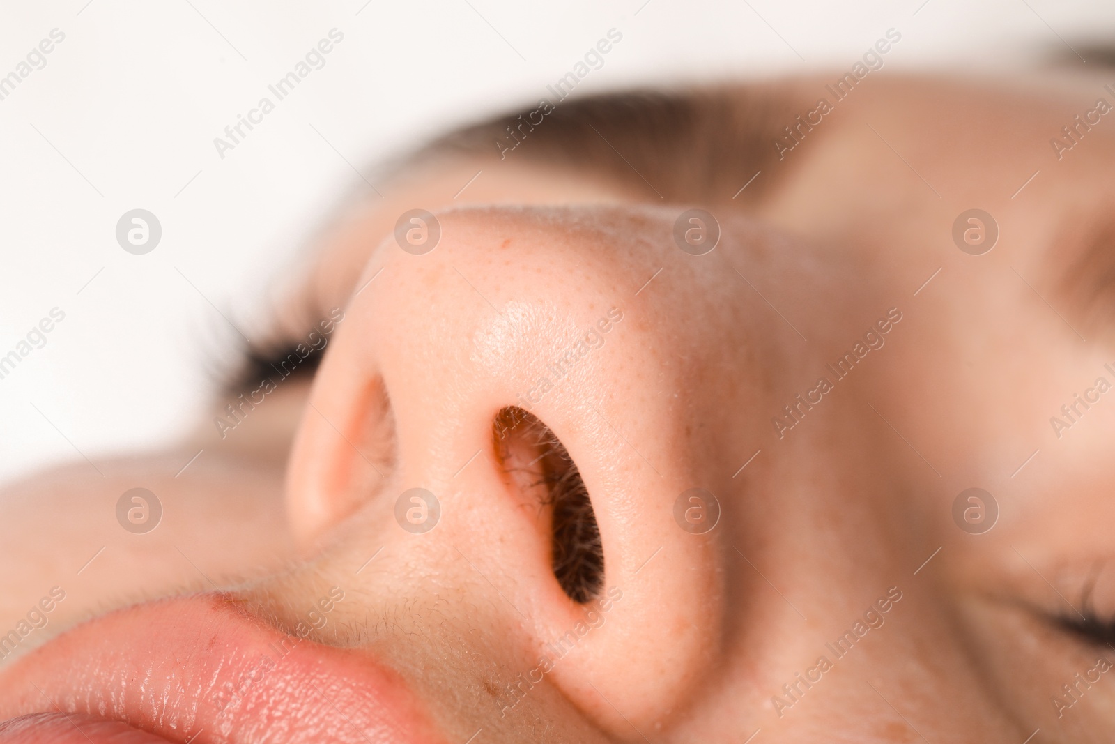 Photo of Woman with normal nasal septum on light background, closeup