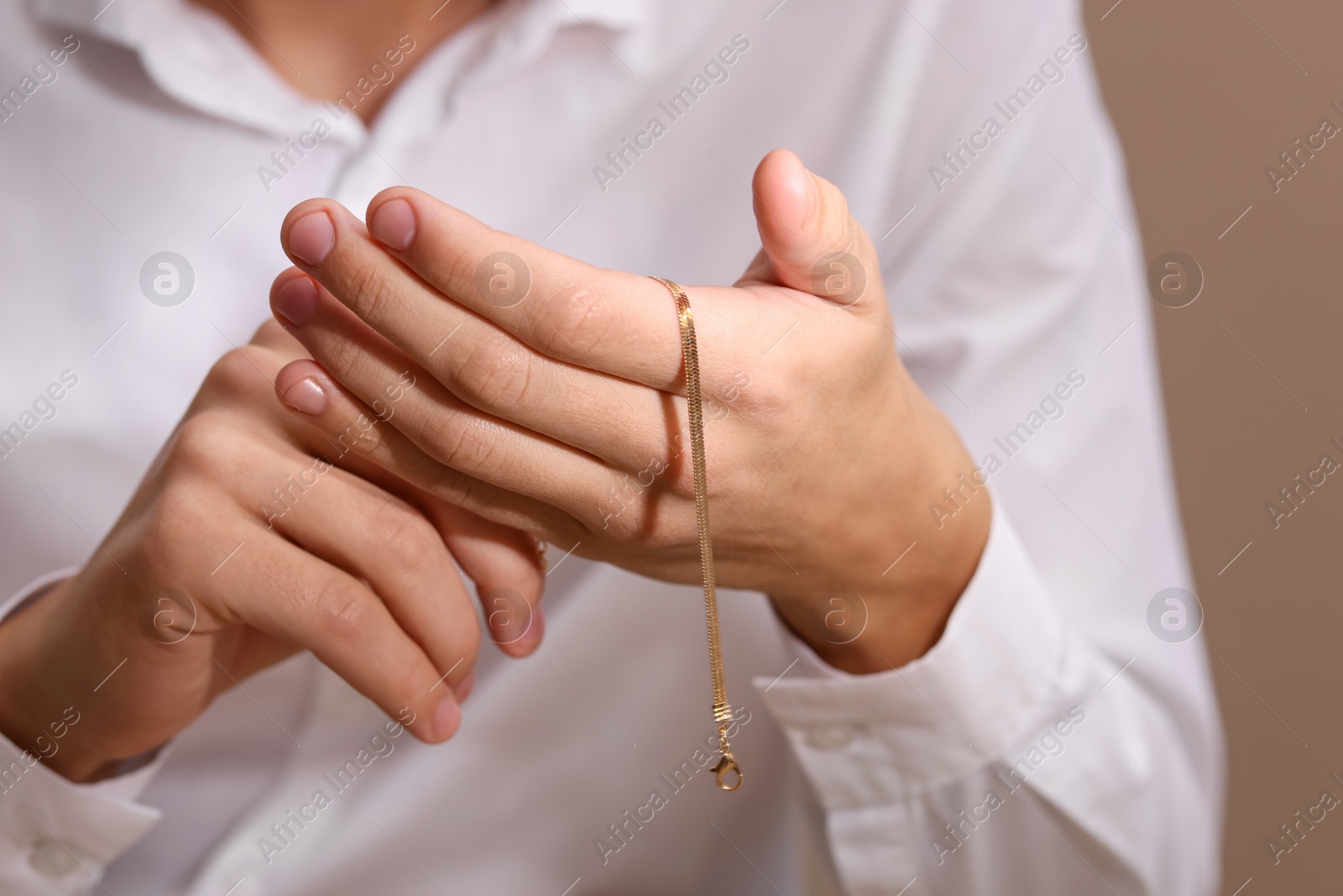 Photo of Appraiser with luxury jewelry on beige background, closeup