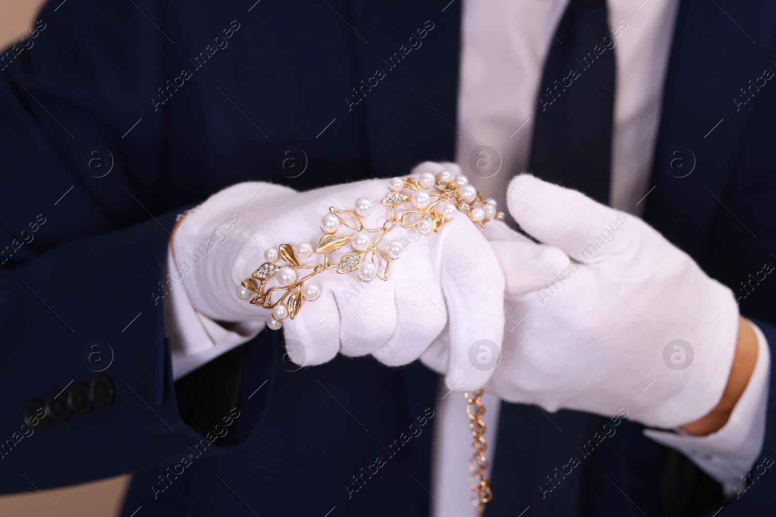 Photo of Appraiser in gloves with luxury jewelry, closeup