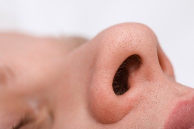 Man with normal nasal septum on light background, closeup