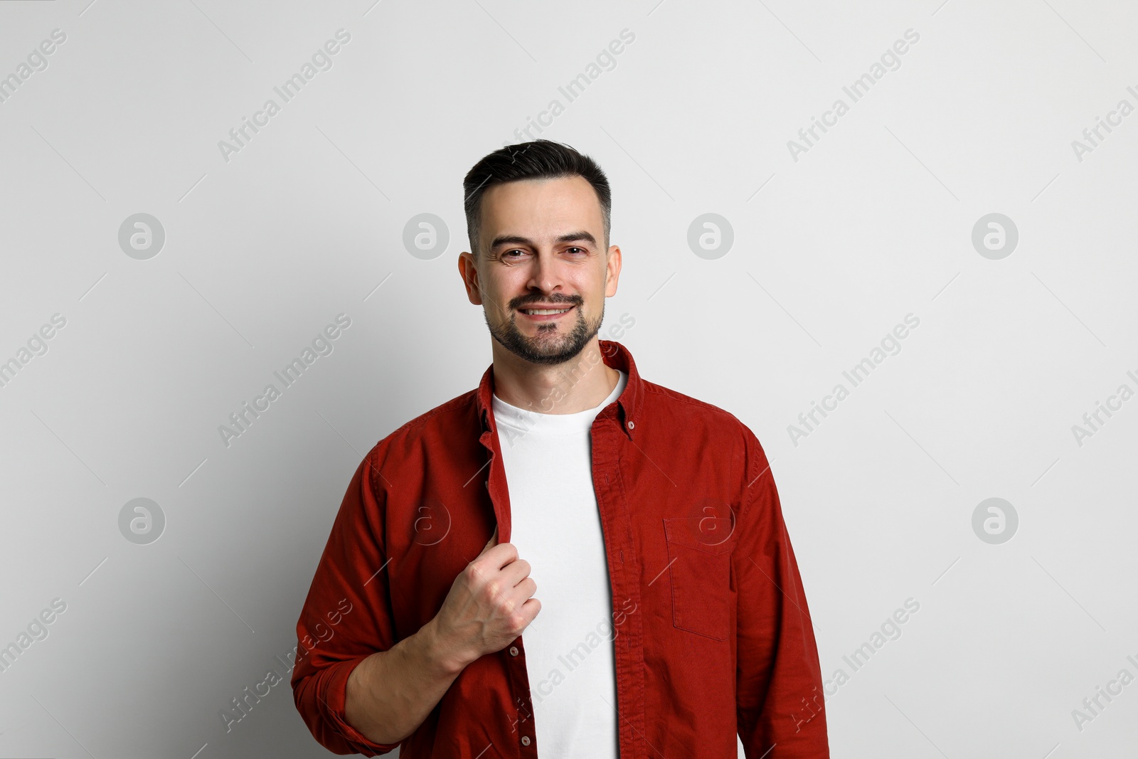 Photo of Portrait of handsome middle aged man on light background, space for text