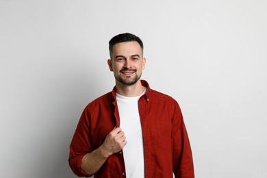 Portrait of handsome middle aged man on light background, space for text