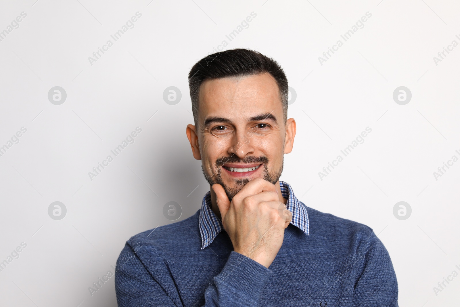 Photo of Portrait of handsome middle aged man on light background