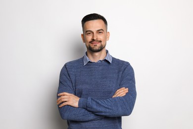 Portrait of handsome middle aged man on light background