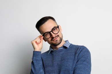 Portrait of handsome middle aged man on light background