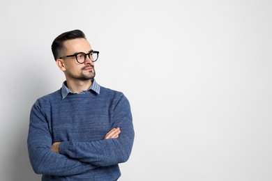 Portrait of handsome middle aged man on light background, space for text