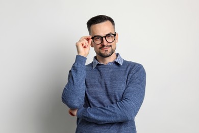 Portrait of handsome middle aged man on light background