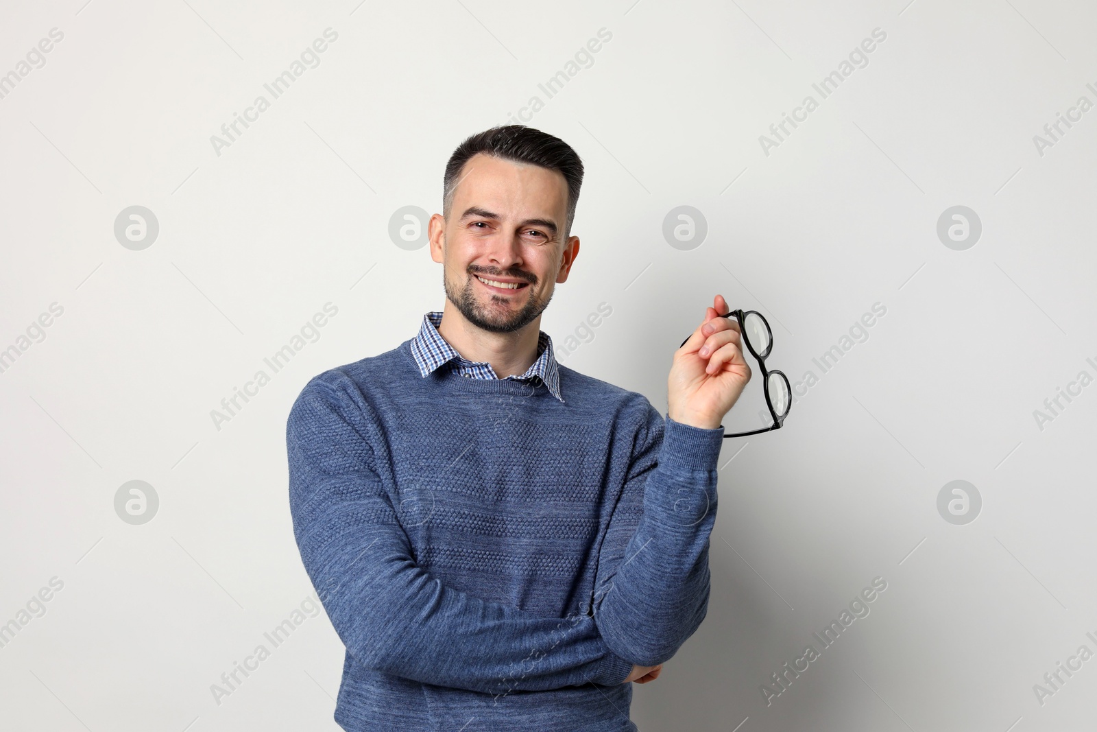 Photo of Portrait of handsome middle aged man on light background