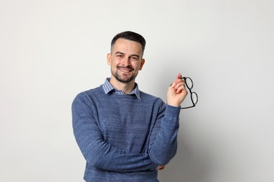 Photo of Portrait of handsome middle aged man on light background