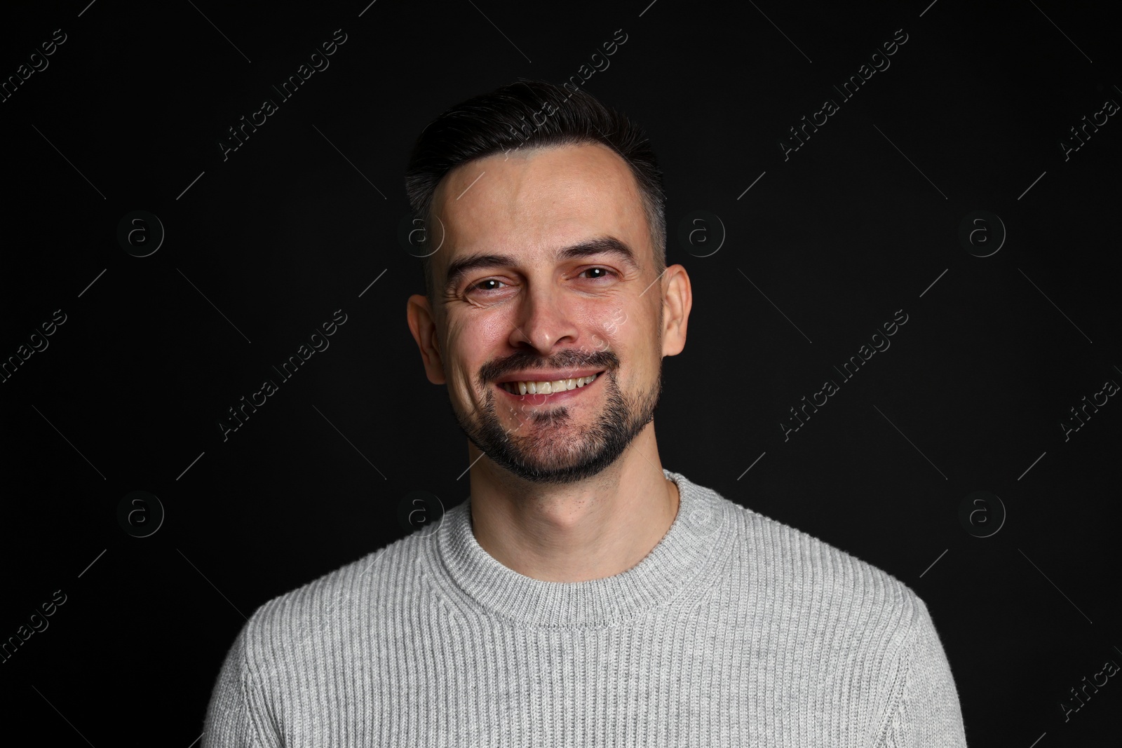 Photo of Portrait of handsome middle aged man on black background