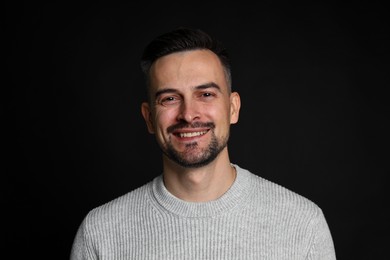 Photo of Portrait of handsome middle aged man on black background