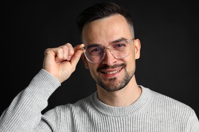 Photo of Portrait of handsome middle aged man on black background