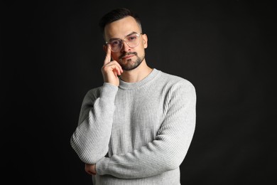 Portrait of handsome middle aged man on black background