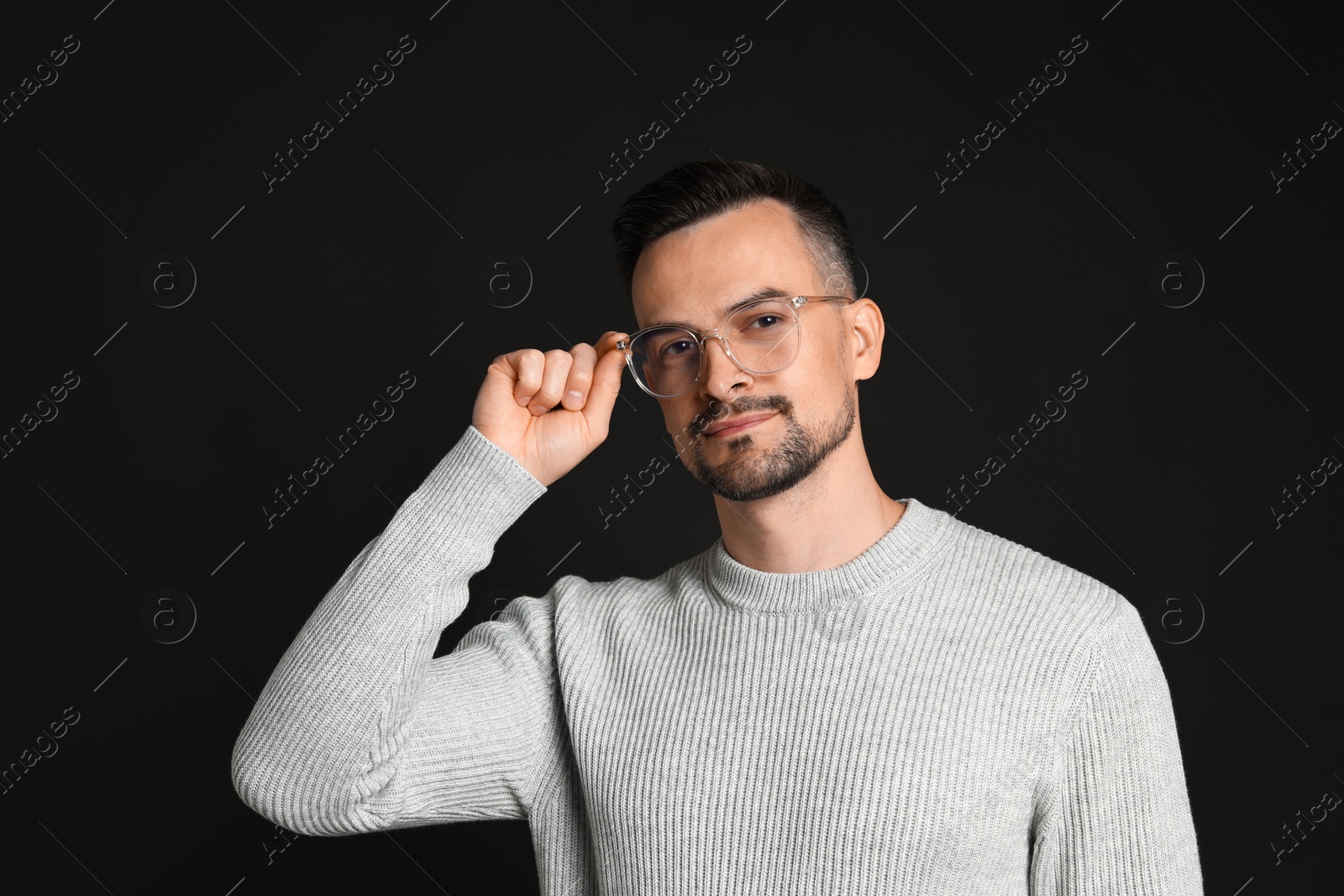 Photo of Portrait of handsome middle aged man on black background