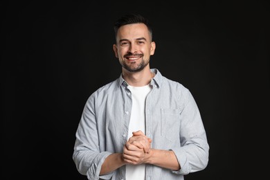 Photo of Portrait of handsome middle aged man on black background