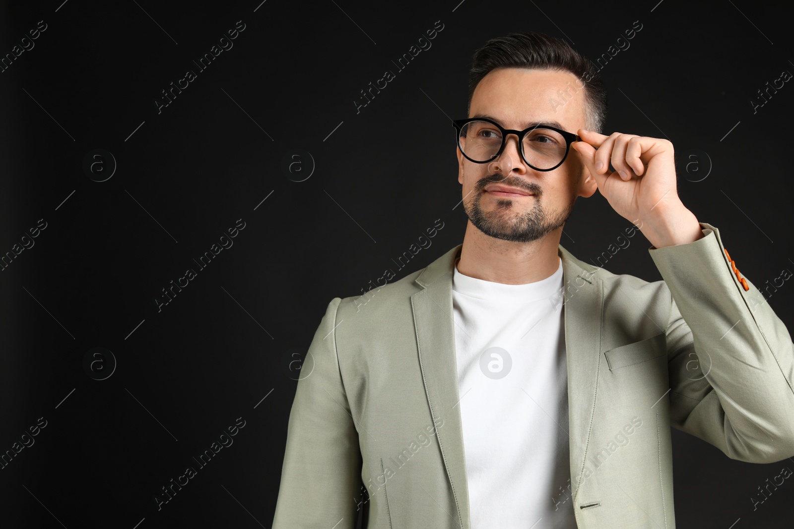 Photo of Portrait of handsome middle aged man on black background, space for text