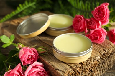 Photo of Natural solid perfume and pink roses on table, closeup