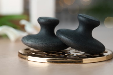 Photo of Massage stones on table, closeup. Spa treatment