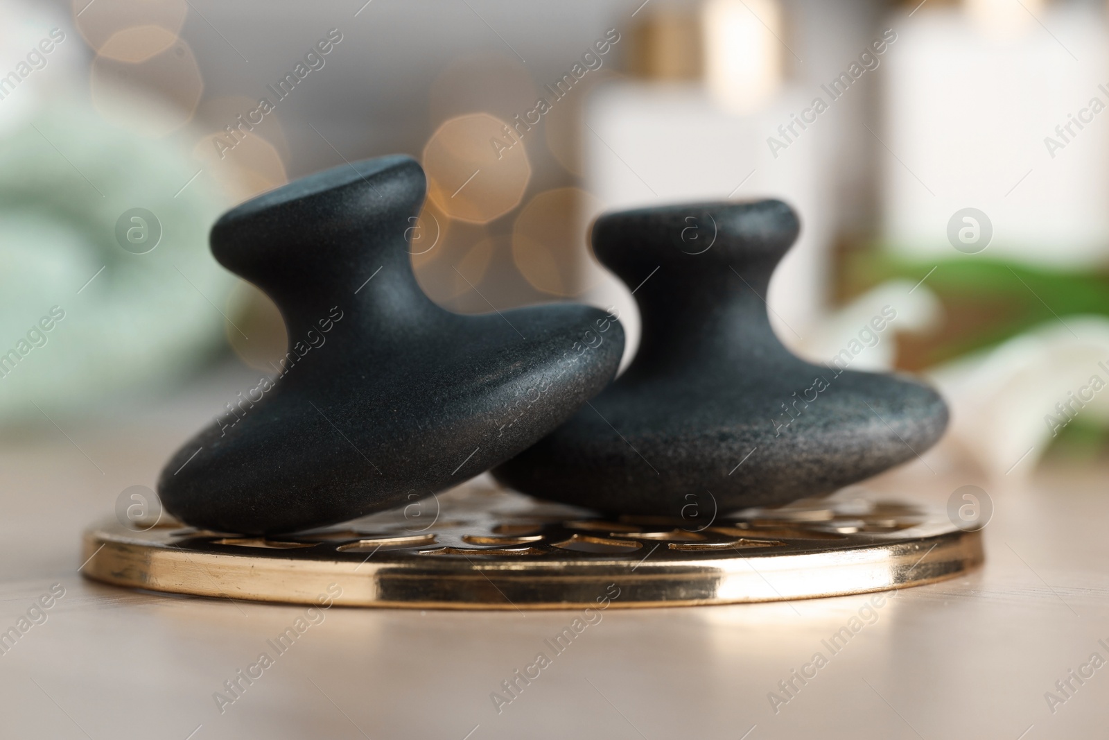 Photo of Massage stones on table, closeup. Spa treatment