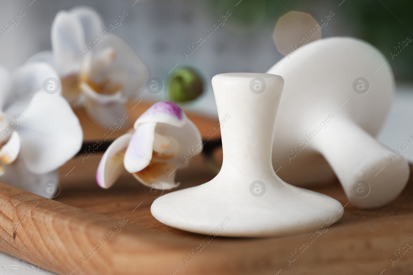 Photo of Spa stones and orchid flowers on table, closeup