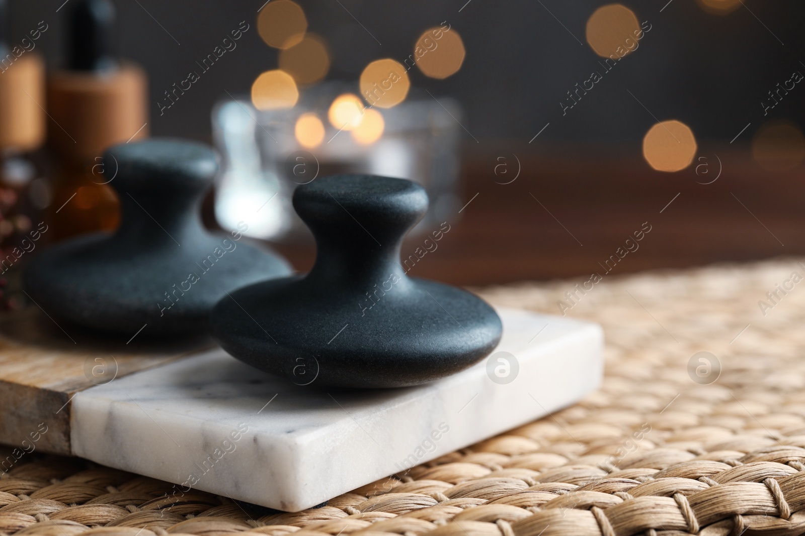 Photo of Spa stones on table, closeup. Space for text