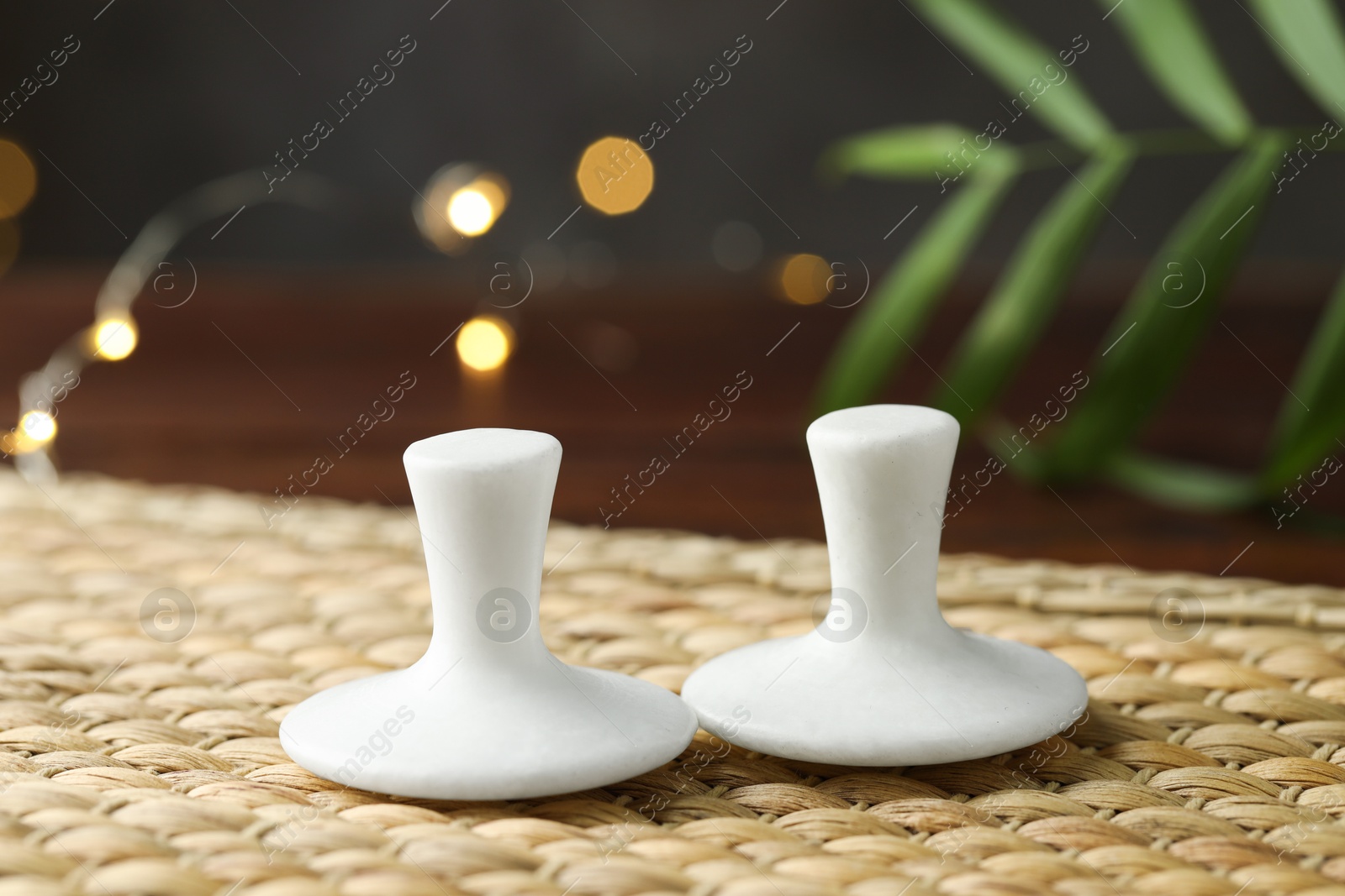 Photo of Two spa stones on wicker mat, closeup