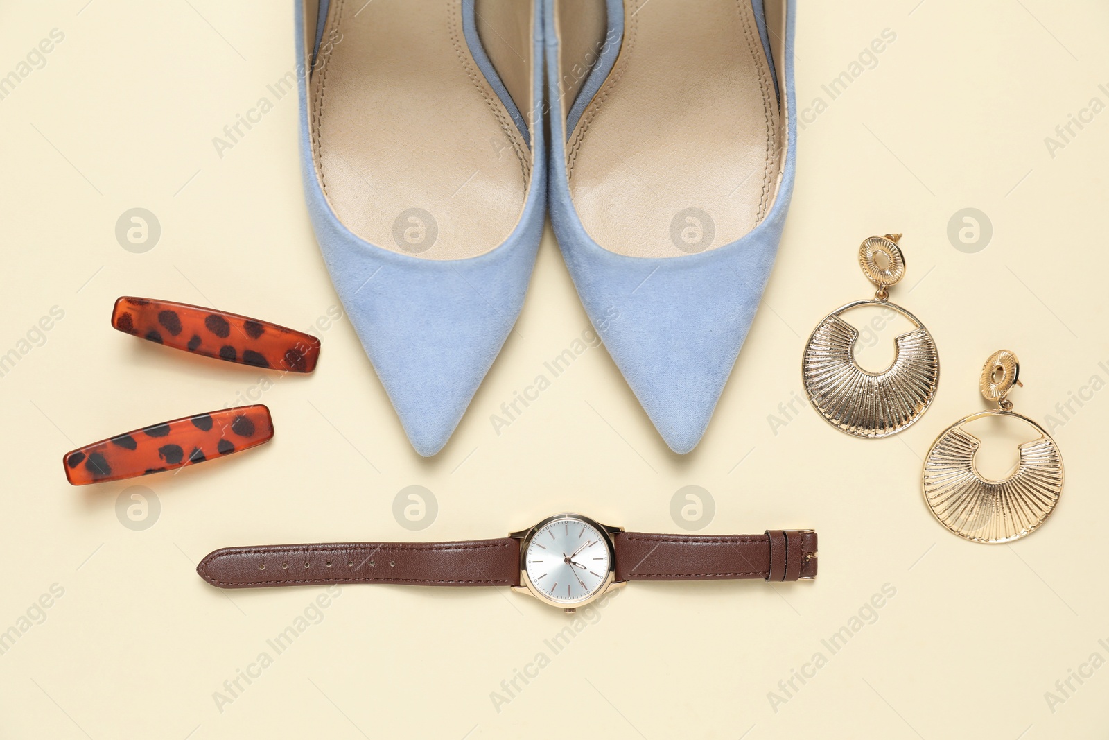 Photo of Flat lay composition with jewelry, accessories and shoes on beige background