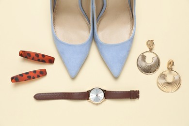 Photo of Flat lay composition with jewelry, accessories and shoes on beige background